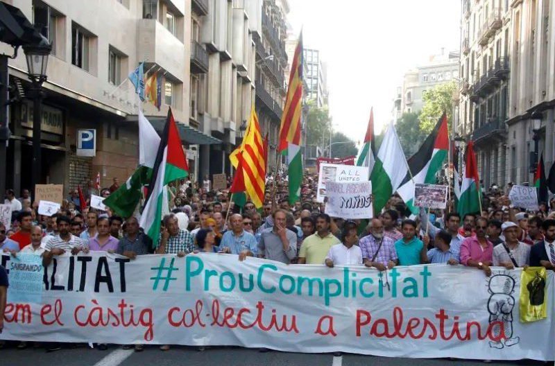 Demonstrators hold a banner during a protest in Barcelona, against Israel's military action in Gaza (photo credit: REUTERS/GUSTAU NACARINO)