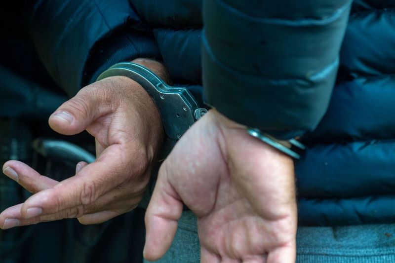A man wears handcuffs. (Photo Stefan SauerdpaIllustration)