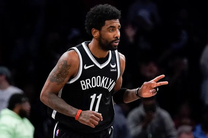 Brooklyn Nets' Kyrie Irving reacts after hitting a basket against the Cleveland Cavaliers during the first half of the opening basketball game of the NBA play-in tournament Tuesday, April 12, 2022, in New York. (AP Photo/Seth Wenig)