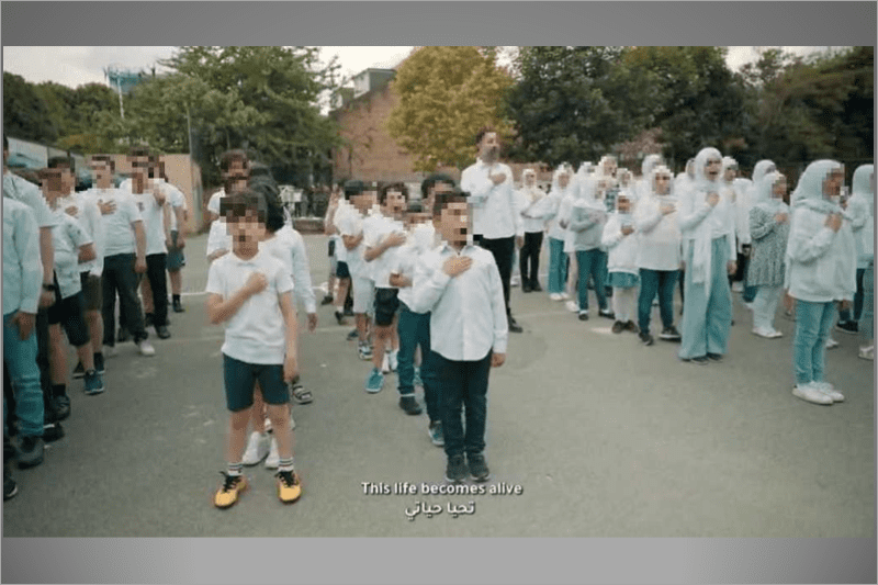 A screengrab from a video showing dozens of children singing a song that references an apocalyptic myth about massacring Jews